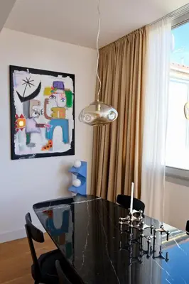 a dining room with a glass table and a painting at Magnifique T3 de 85m2 de standing vue mer trottel in Ajaccio