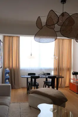 a living room with a table and a couch at Magnifique T3 de 85m2 de standing vue mer trottel in Ajaccio