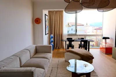 a living room with a couch and a table at Magnifique T3 de 85m2 de standing vue mer trottel in Ajaccio
