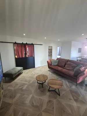 a living room with a couch and two tables at CasaKia in Pietralba