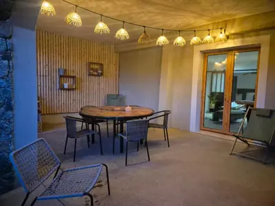 a dining room with a table and chairs and lights at CasaKia in Pietralba