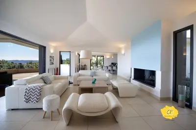 a living room with white furniture and a fireplace at Villa d’exception 4 chambres, piscine, vue mer in Porto-Vecchio