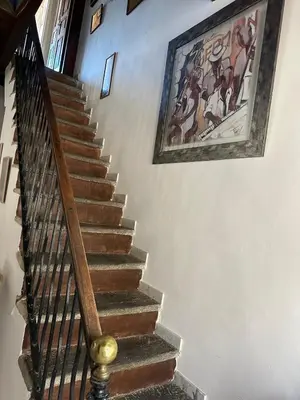 a staircase in a house with a painting on the wall at Charming village house in Cambia