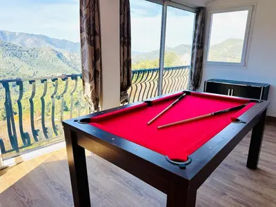a pool table in front of a balcony with a view at Charming village house in Cambia