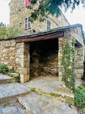 an entrance to a stone building with a stone wall at Charming village house in Cambia