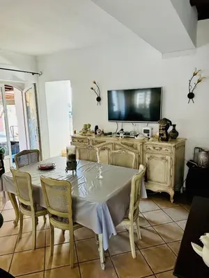 a dining room with a table and a flat screen tv at Charming village house in Cambia