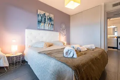 a bedroom with a large bed with towels on it at Clos Vignola - Domaine de la Viva -Superbe vue mer in Grosseto-Prugna