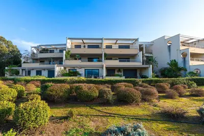 an apartment building with bushes in front of it at Clos Vignola - Domaine de la Viva -Superbe vue mer in Grosseto-Prugna