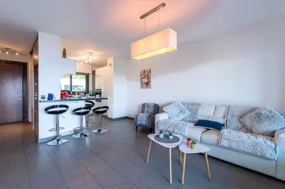 a living room with a couch and a kitchen at Clos Vignola - Domaine de la Viva -Superbe vue mer in Grosseto-Prugna