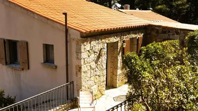a house with a stone building with a roof at Domaine de Gialla Bergerie Carta, 6 pers, montagne, vue mer in Porto-Vecchio