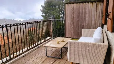 a patio with a table and chairs on a balcony at Domaine de Gialla Bergerie Carta, 6 pers, montagne, vue mer in Porto-Vecchio
