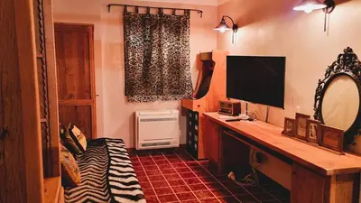 a room with a desk with a television and a window at Domaine de Gialla Bergerie Carta, 6 pers, montagne, vue mer in Porto-Vecchio