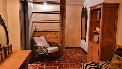 a living room with a chair in a room at Domaine de Gialla Bergerie Carta, 6 pers, montagne, vue mer in Porto-Vecchio