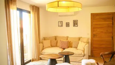 a living room with a couch and a table at Domaine de Gialla Bergerie Quercia, 2 pers, piscine chauffée, 10 mn plage in Arraggio