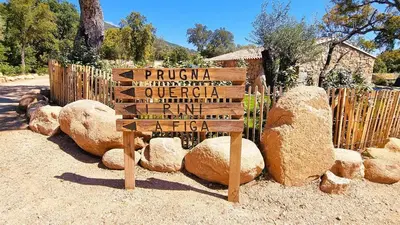 a wooden sign sitting in front of a fence at Domaine de Gialla Bergerie Quercia, 2 pers, piscine chauffée, 10 mn plage in Arraggio