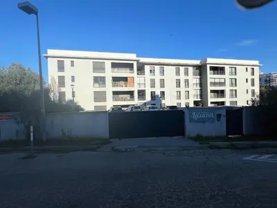 an empty parking lot in front of a building at Luxury residence apartment with sea view, parking in Ajaccio