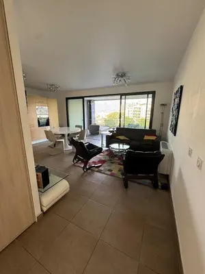 a living room with a couch and a table at Luxury residence apartment with sea view, parking in Ajaccio