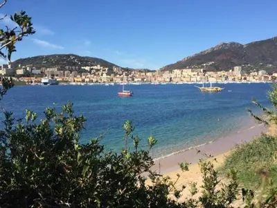 a view of a beach with boats in the water at Luxury residence apartment with sea view, parking in Ajaccio