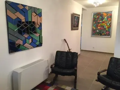 a room with two chairs and a painting on the wall at Luxury residence apartment with sea view, parking in Ajaccio