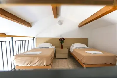 a resort with a swimming pool with chairs and umbrellas at Appartement 3 étoiles - Piscine - ccaiibh in Linguizzetta