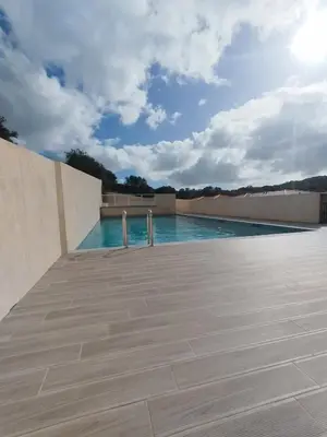 a swimming pool on top of a building at villa jérémy in Bonifacio