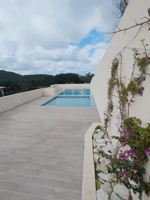 a swimming pool on the roof of a house at villa jérémy in Bonifacio