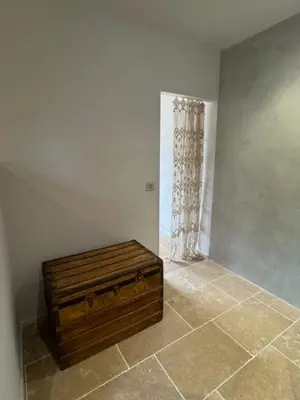 a wooden chest in a room with a window at casa di santa in Aléria