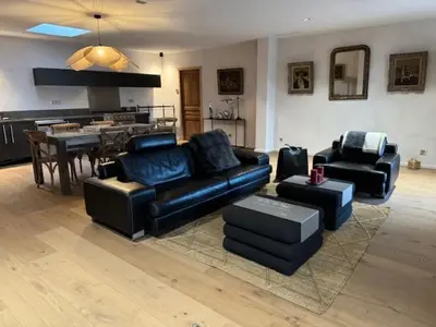 a living room with black leather furniture and a table at casa di santa in Aléria