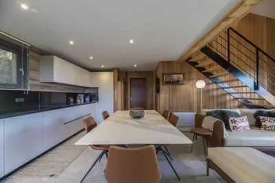 a kitchen and dining room with a table and chairs at Chalet U Picculu Di Arasu in Sainte-Lucie de Porto-Vecchio