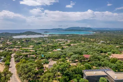 an aerial view of a town with a lake and trees at Chalet U Picculu Di Arasu in Sainte-Lucie de Porto-Vecchio