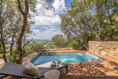 a swimming pool in the middle of a yard at Chalet U Picculu Di Arasu in Sainte-Lucie de Porto-Vecchio