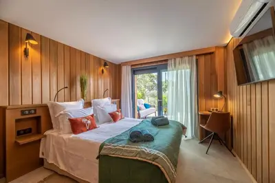 a bedroom with a large bed and a window at Chalet U Picculu Di Arasu in Sainte-Lucie de Porto-Vecchio