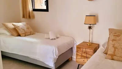 a bedroom with a bed and a lamp on a table at Domaine de Gialla Bergerie I Pini, 8 pers, piscine chauffée, 10 mn plage in Arraggio
