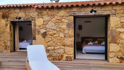 a stone house with two beds in a patio at Domaine de Gialla Bergerie I Pini, 8 pers, piscine chauffée, 10 mn plage in Arraggio