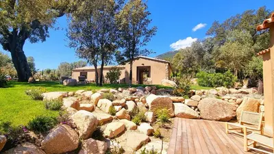 a rock garden in front of a house at Domaine de Gialla Bergerie Prugna, 8 pers, piscine chauffée, 10 mn plage in Arraggio