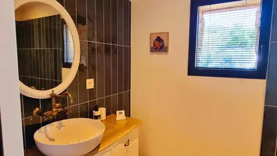 a bathroom with a sink and a mirror at Domaine de Gialla Bergerie Prugna, 8 pers, piscine chauffée, 10 mn plage in Arraggio