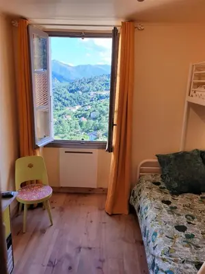 a bedroom with a large window with a view at 10 min de Cortè, 5 couchages, in Venaco