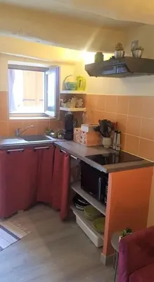 a kitchen with a sink and a stove top oven at 10 min de Cortè, 5 couchages, in Venaco