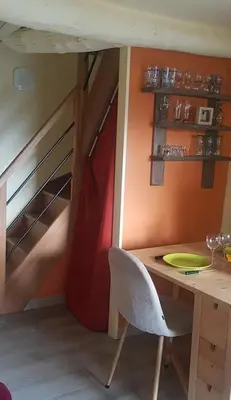 a room with a table and a chair in a room at 10 min de Cortè, 5 couchages, in Venaco