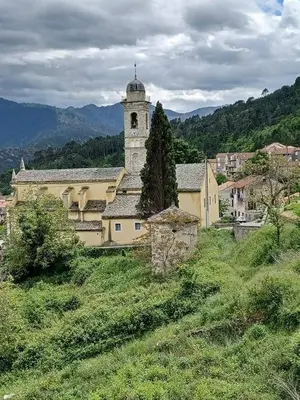 a building with a clock tower on top of a hill at 10 min de Cortè, 5 couchages, in Venaco
