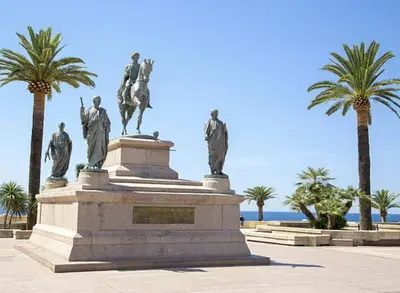 a monument with statues on top of it with palm trees at Superbe Studio pieds dans l'eau - Parking gratuit - Terrasse - Emplacement idéal dans résidence de standing in Ajaccio