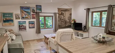 a living room with a table and a couch at Stalla in Ortiporio