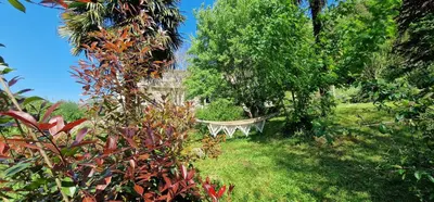 a hammock in the middle of a garden with trees at Stalla in Ortiporio