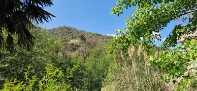 a mountain with a house on top of it at Stalla in Ortiporio
