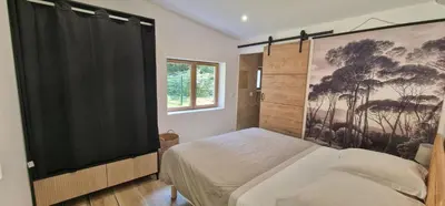 a bedroom with a bed with a large screen at Stalla in Ortiporio