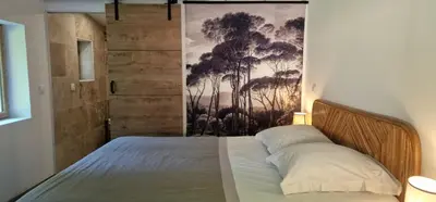 a bedroom with a bed with a painting on the wall at Stalla in Ortiporio