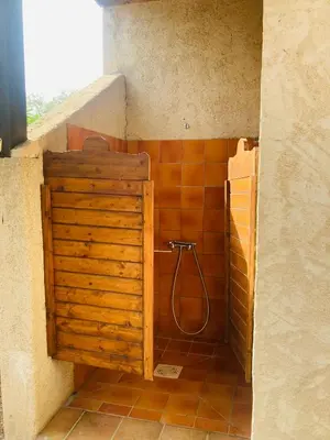 a bathroom with a shower with a wooden cabinet at Villa Chérie 120m2 - Bord de Mer - Olmuccio 9 pers in Zonza