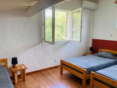 a bedroom with two beds and a window at Villa Chérie 120m2 - Bord de Mer - Olmuccio 9 pers in Zonza