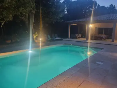 a swimming pool at night with lights on it at Villa Stellalilou in Porto-Vecchio