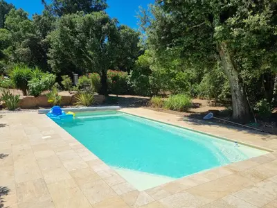 a swimming pool in a yard with trees at Villa Stellalilou in Porto-Vecchio